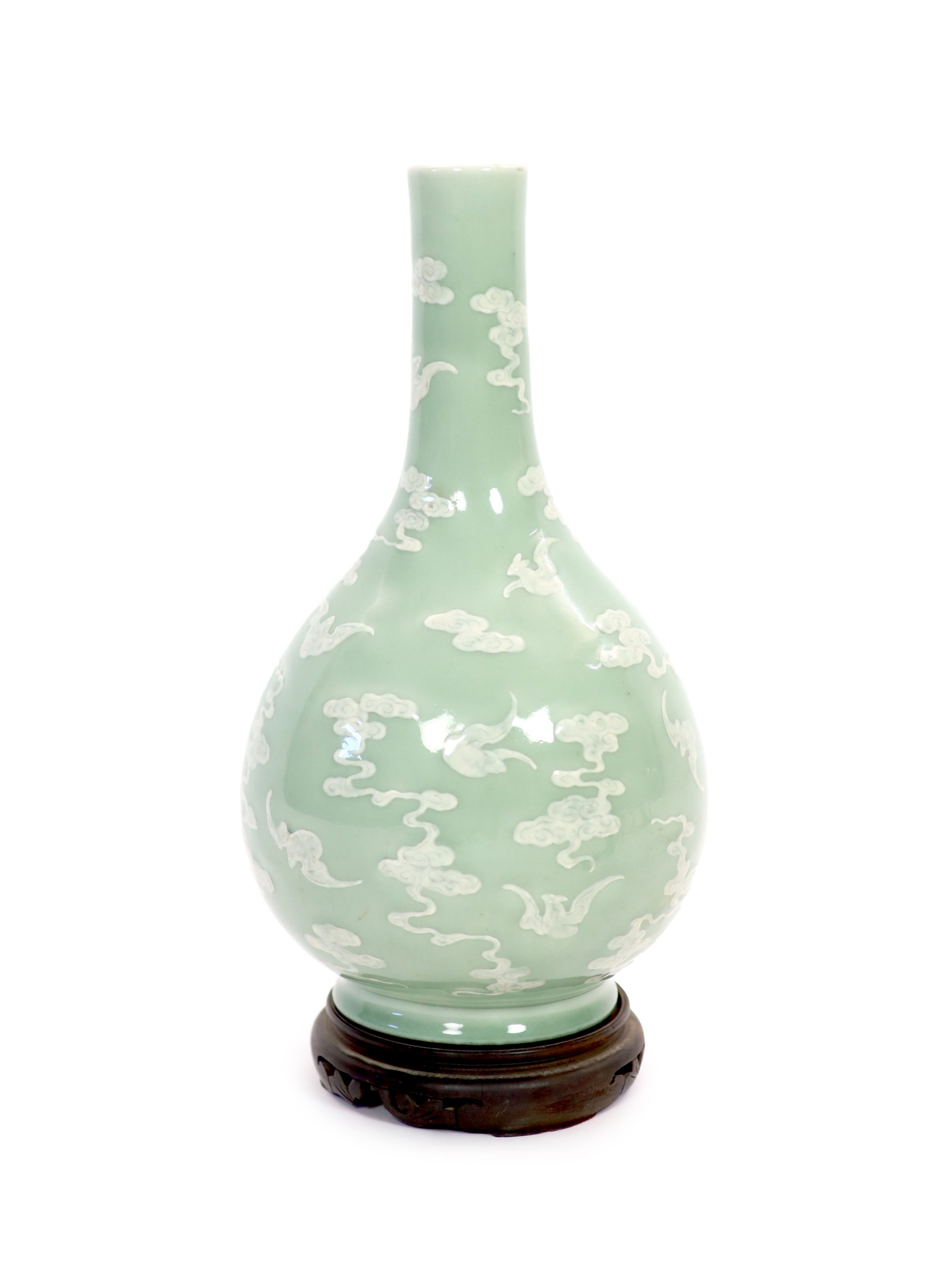 A Chinese celadon-glazed slip-decorated bottle vase, Qianlong seal mark and period (1736-95), Formerly mounted as a lamp with drilled hole through the seal mark and base.